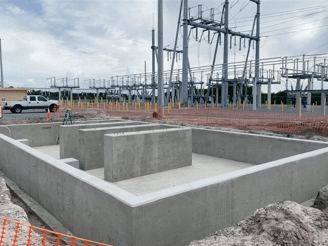 The finished poured walls, forms stripped, standing in front of the substation.